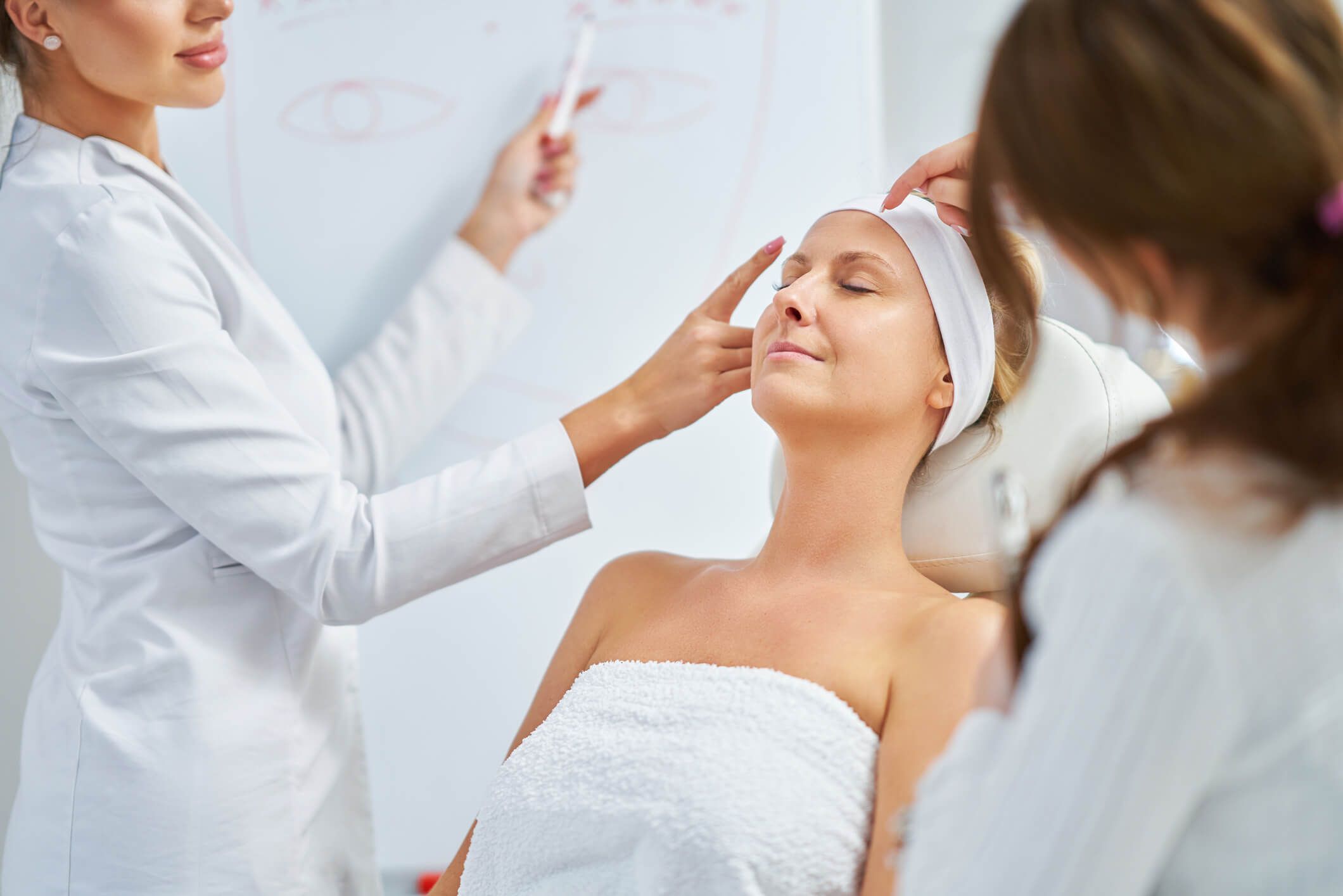 Matt Azulay-LaFever and a student delivering sculptra injections to a patient model