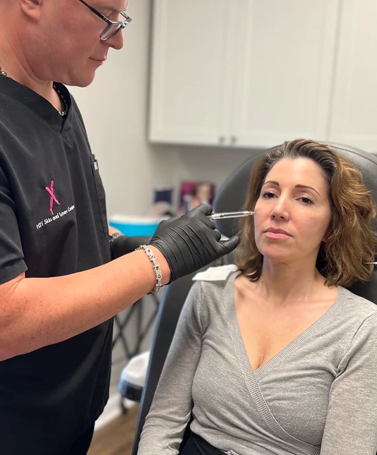 nurse injector student delivering an injectable into a patient model's cheek