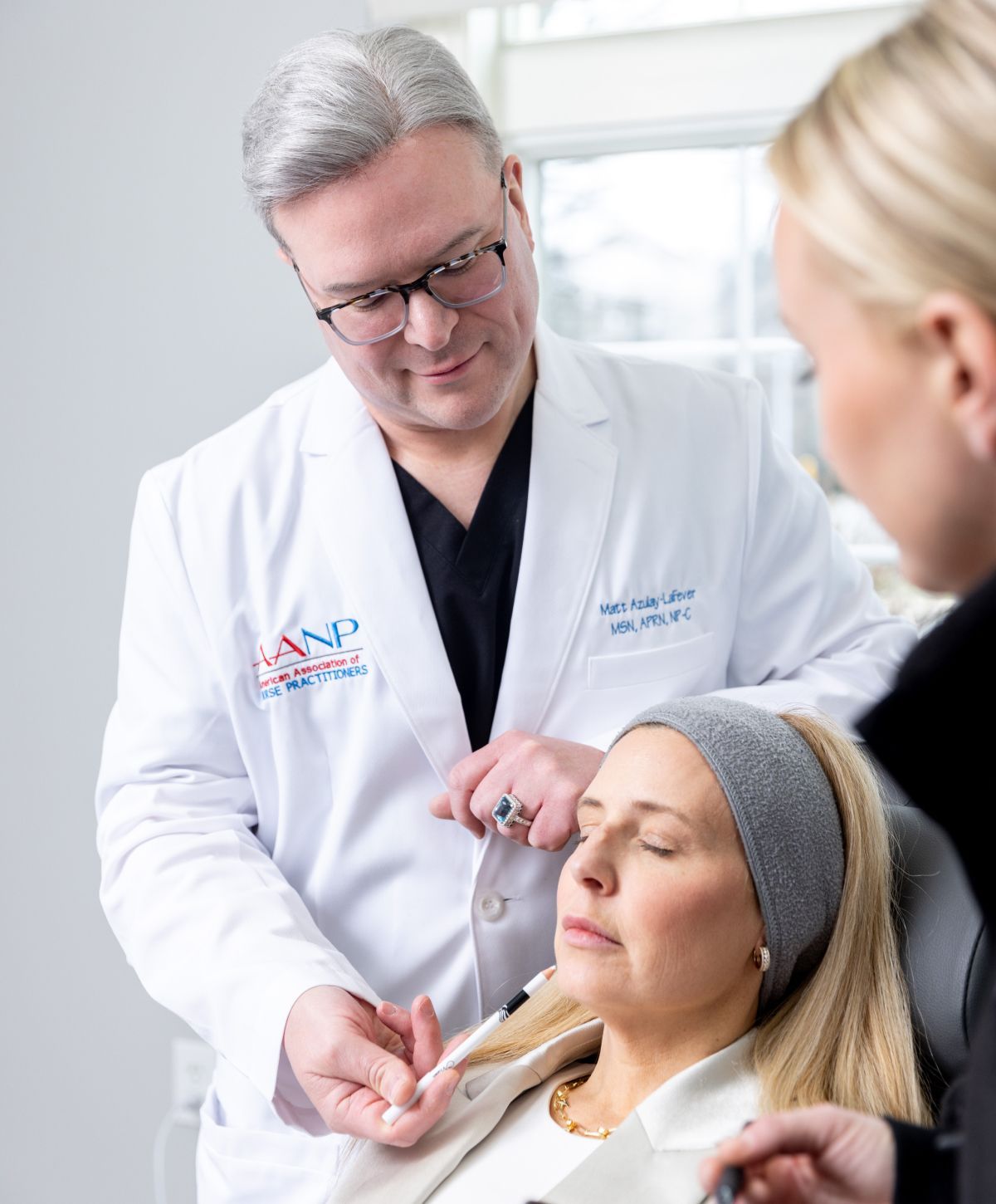 Matt Azulay-LaFever and a student treating a patient model in a chair