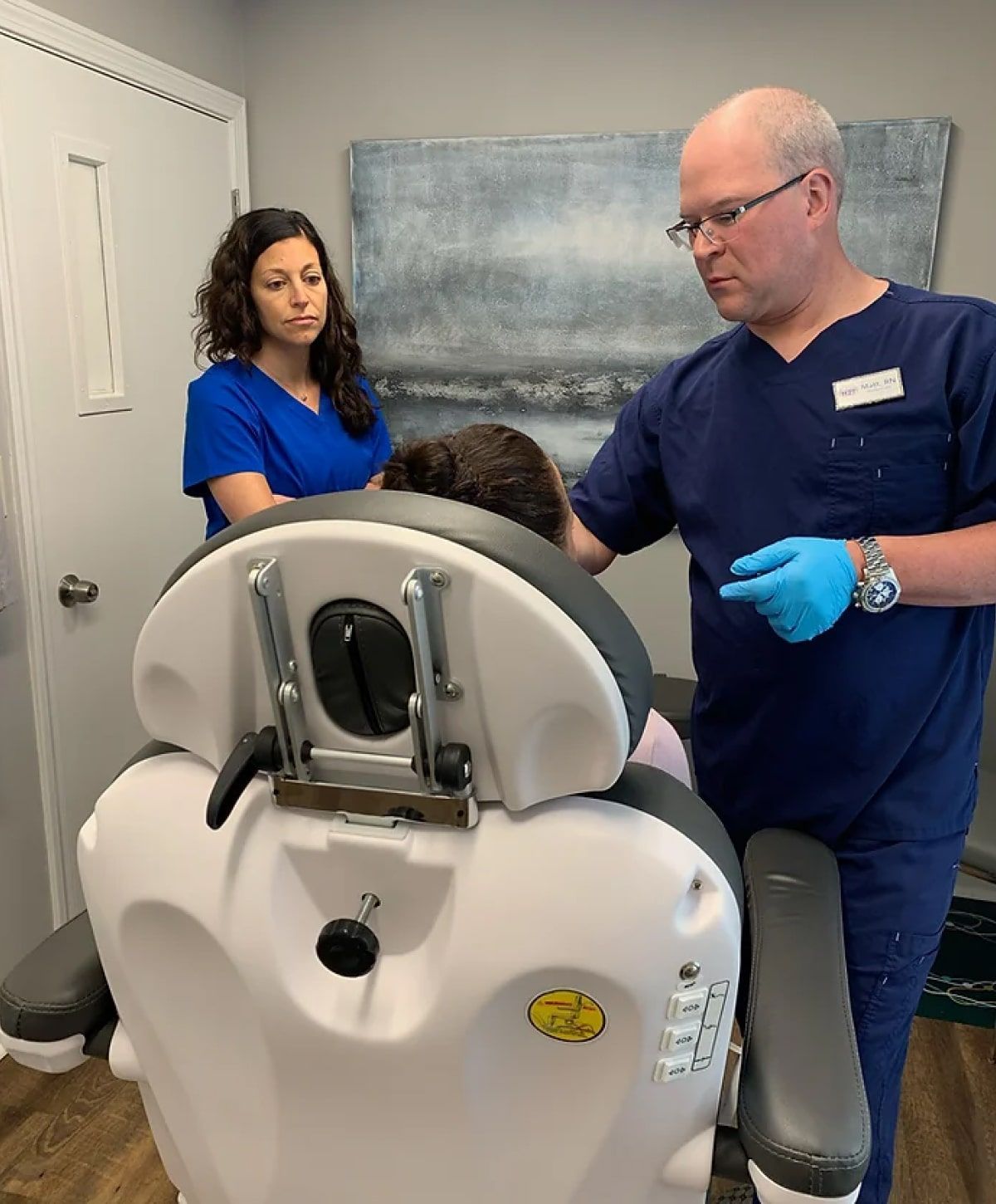 complications management student with their instructor seeing a patient model in a med spa chair