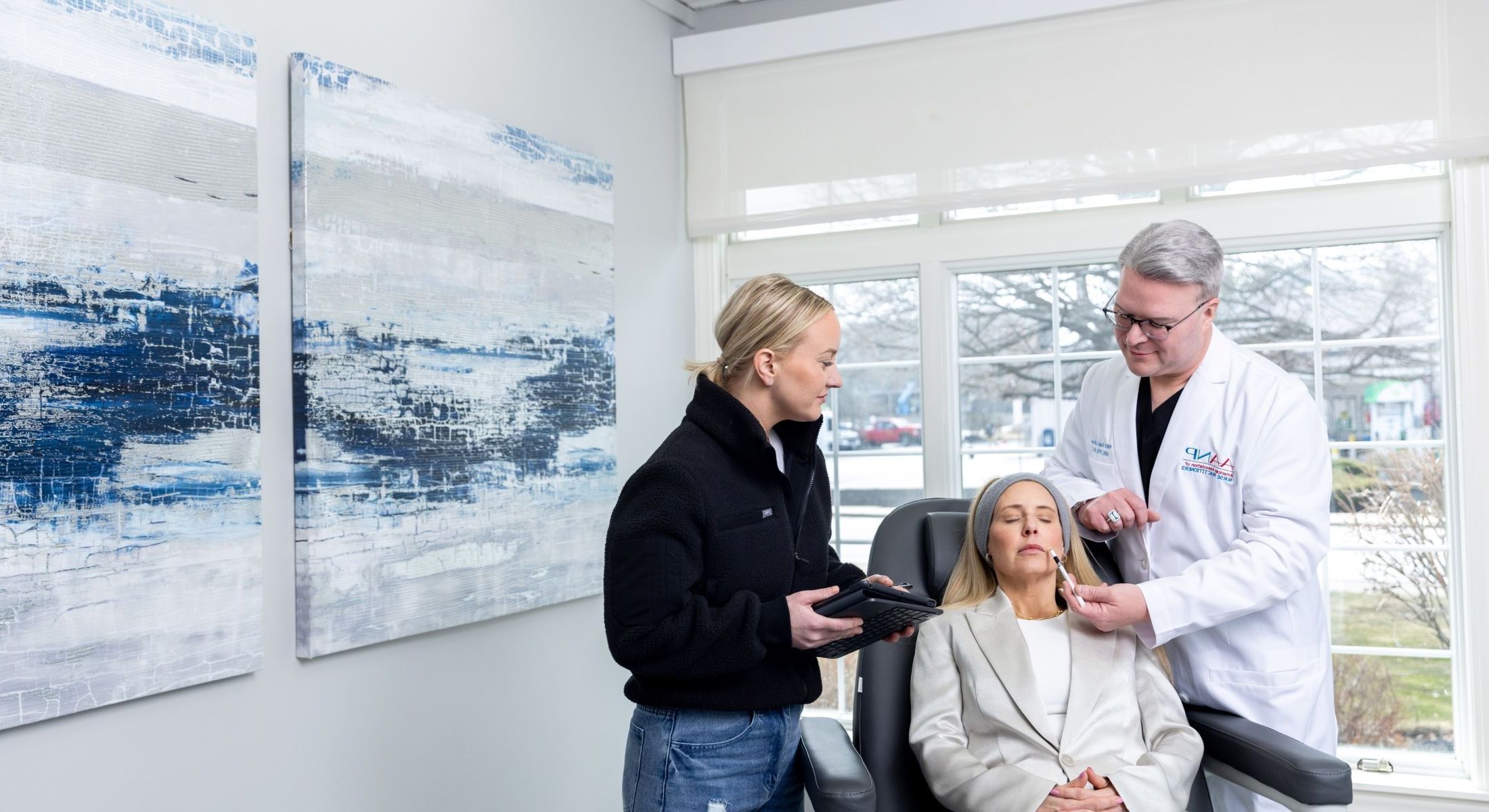 Matt Azulay-LaFever with a student and a patient model sitting in the chair