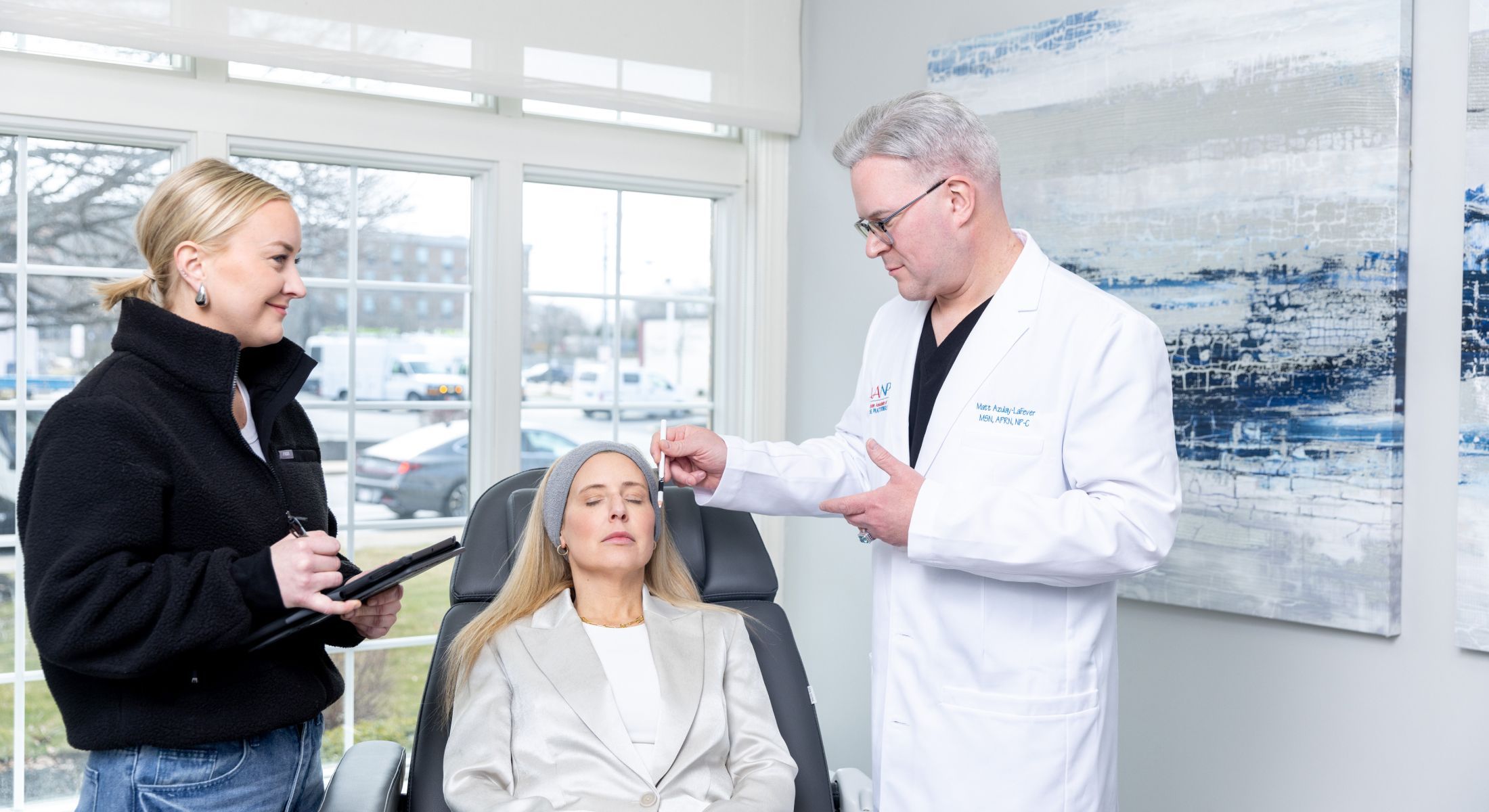 Matt Azulay-LaFever with a student delivering skinvive to a patient model